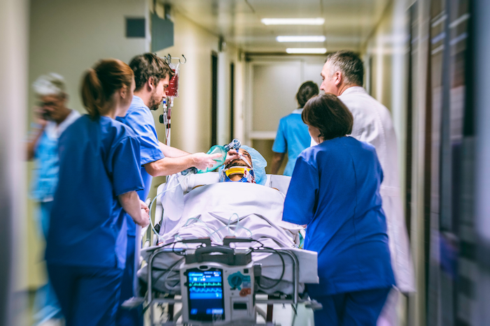 emergency-medical-team-transporting-patient-on-gurney-1